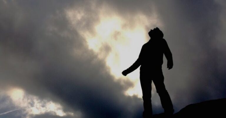 man looking up hands