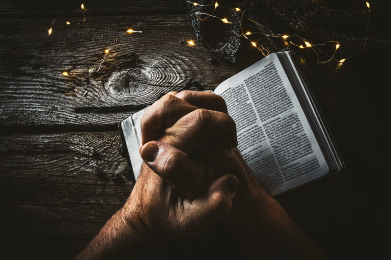 prayer hands bible table